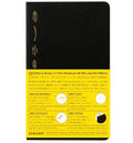 A notebook package shown against a black background, with the front cover in black and the back panel in bright yellow. The cover has gold-toned branding and the back includes product text and small usage diagrams.